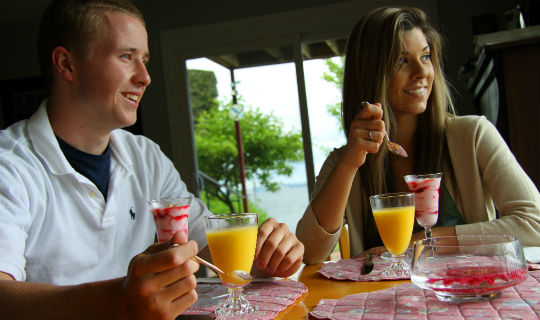 Couple eating breakfast at a table in their Bed & Breakfast